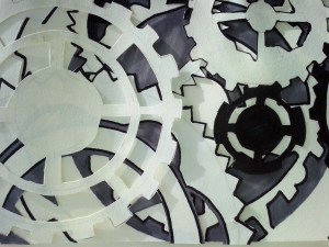 Layered paper cut out cogs. 